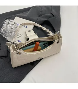 Interior view of off-white crocodile texture baguette bag with daily essentials inside