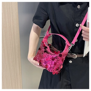 Detail of fuchsia sequin crescent bag with metallic finish and adjustable strap