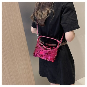 Detail of fuchsia sequin shoulder bag showing textured shimmer and slim strap design