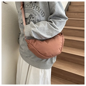 Detailed view of dusty pink crescent bag with wide adjustable shoulder strap