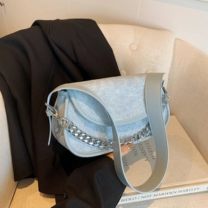 Minimalist light blue underarm baguette bag with silver chain and wide strap detail