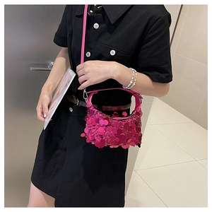 Detail of rose red sequin crossbody bag with large round sequins and metallic strap links