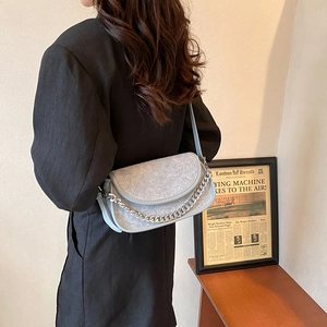 Chic light blue dumpling shoulder bag for women with stylish silver chain strap detail