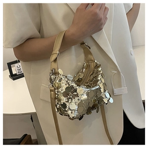 Detailed close-up of a gold hobo bag with large metallic sequins and a matching handle