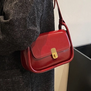 Vintage red crossbody bag in premium oil wax leather with gold buckle on tweed coat