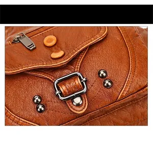 Macro view of brown vintage washed leather texture with rivet studs and metal buckle detail