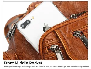 Detail of vintage brown washed leather tote showing large front pocket for phone and tablet