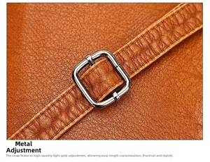 Macro shot of adjustable brown leather shoulder strap with polished metal rectangle buckle