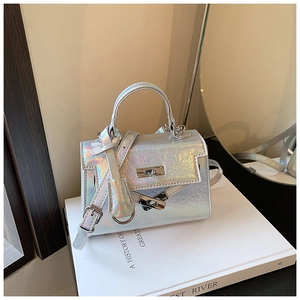 Macro detail of holographic silver mini bag featuring metallic crackle texture and metal lock