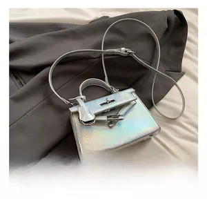 Detail of silver holographic mini crossbody bag with sleek metallic hardware and handle
