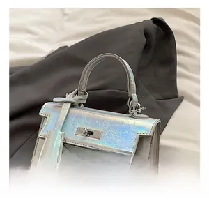 Detail shot of the iridescent laser texture and silver metallic hardware on the bag