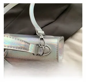 Detail of crinkled iridescent silver fabric and high-quality metallic hook buckle