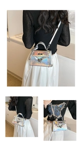 Detail view of silver holographic crossbody bag with metallic lock and V-stitch texture