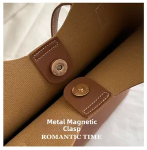 Close-up of the magnetic snap closure on a brown tote bag with high-quality stitching