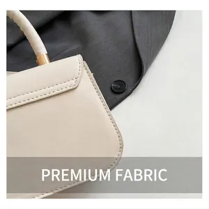 Detailed close-up of cream leather texture and golden hardware on this saddle bag