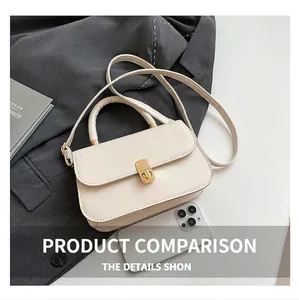 Detailed top view of an ivory leather handbag showing its size relative to a smartphone