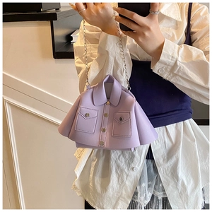 Macro detail of lavender jacket-style mini handbag with silver chain strap and buttons