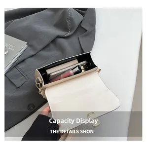 Overhead view showing spacious inner compartment of the beige crossbody bag with daily items