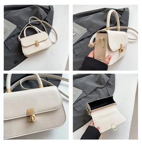 Detail view of white square handbag showing gold clasp hardware and interior space