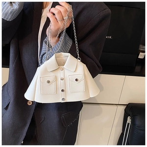 Detail of shirt-shaped white leather clutch with metal chain and silver button accents