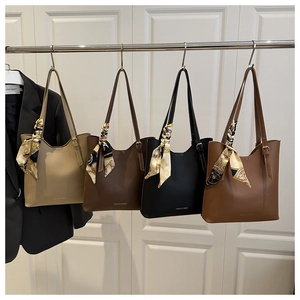 Detail view of large tote bags in four colors with decorative silk scarves for commuting