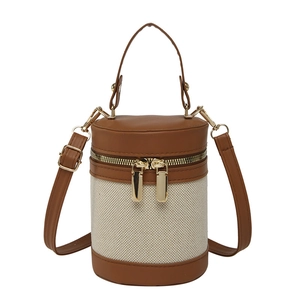 Retro canvas and brown leather barrel crossbody bag with gold-tone metal hardware details