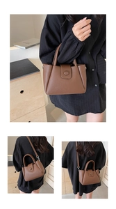 Close-up of brown pebble leather texture and metal chain strap on a women's bucket bag
