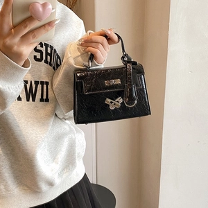 Chic black glossy patent leather mini handbag with silver twist lock for women