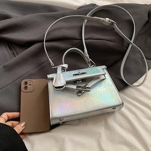 Mini holographic silver Kelly style handbag with glossy finish and crossbody strap