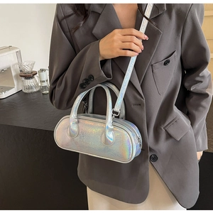 Close-up of holographic silver mini boston bag with snake texture on a model