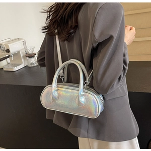 Lifestyle view of laser silver holographic crossbody bowling bag on model in a cafe