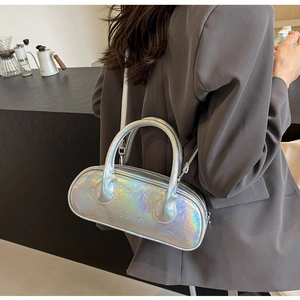 Detail of silver laser bowling bag featuring pleated texture and adjustable strap on model