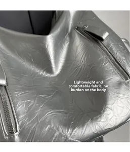 Detailed macro view of crinkled silver metallic fabric with zipper on a chic tote bag