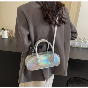 Model wearing an iridescent silver bowling bag with a metallic pearlescent finish