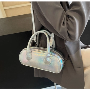 Detail of silver holographic bowling bag showing pleated texture and sleek top handles