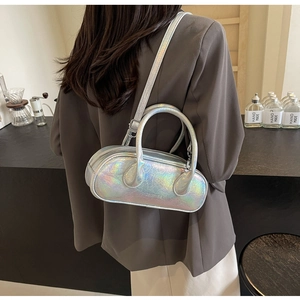 Iridescent silver bowling bag detail with laser leather texture and metallic shine