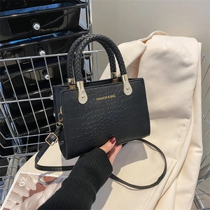 Fashionable black crocodile pattern handbag with woven handle and gold hardware