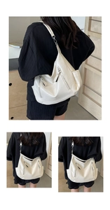 Detail of white moon crossbody bag featuring smooth texture and silver zipper accents