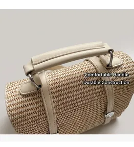 Detail of woven straw handbag with creamy leather handle and silver metal ring buckle