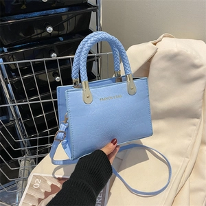 Light blue crocodile pattern square handbag with unique woven handle and gold hardware