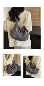Detail view of the dark grey crescent hobo bag featuring retro multi-zipper pockets and texture