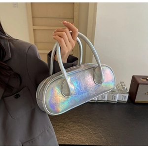 Detail of silver holographic bowling bag with textured pleats and slim round handles