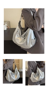 Close-up of metallic silver crescent bag featuring liquid wrinkle texture and multi-zippers