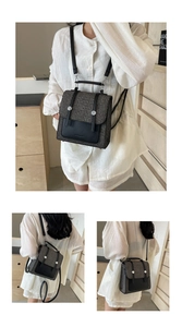 Three-way carry woven backpack with black leather trim and dual metal buckles detail