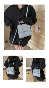 Three-way carry display of straw backpack in light blue leather and woven fabric