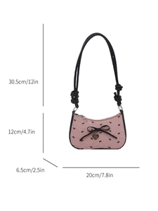 Sac à bandoulière rose avec nœuds noirs contrastés et pendentif cœur de style Y2K