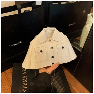 Detail of creative white leather clothing-shaped handbag with lapels and metal chain strap