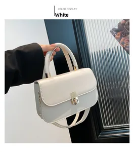 Detailed close-up of white PU leather bag featuring a gold metal buckle and sturdy top handle