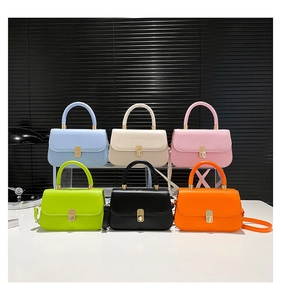 Six colorful minimalist saddle handbags with glossy finish and gold metal swivel locks