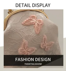 Close-up of pink silk fabric with 3D butterfly embroidery and vintage metal clasp